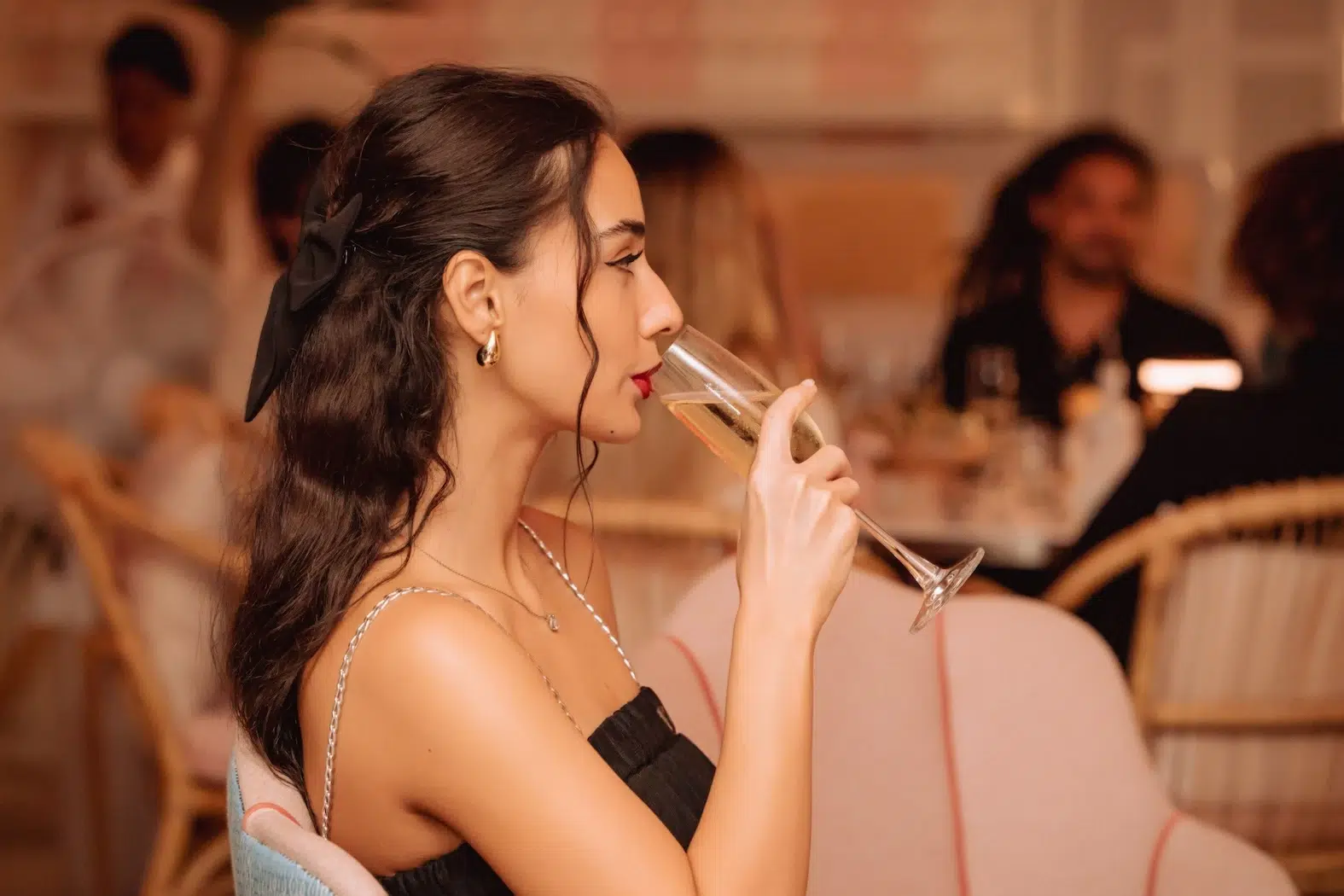 Elegant girl drinking champagne at the romantic Mami Rose restaurant in Bangkok