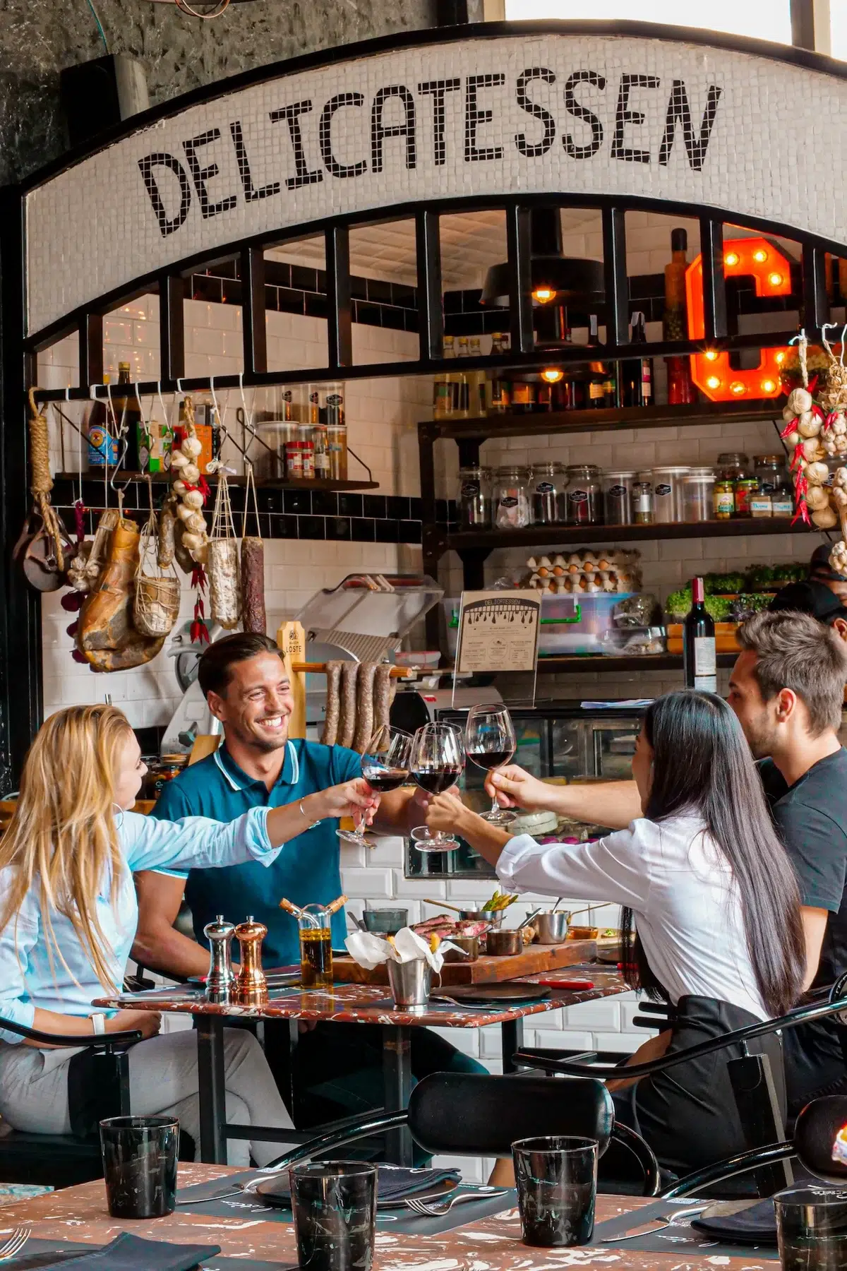 A group of friends celebrated there moments while holding a glass filled of wine.