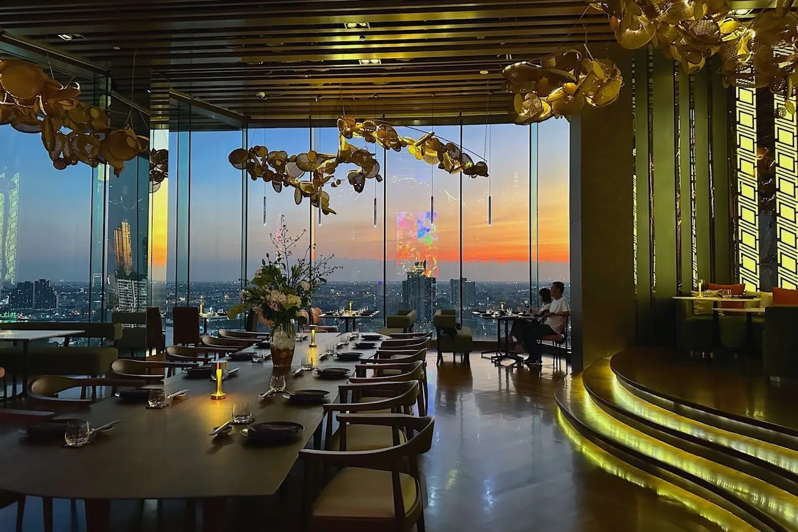 This is the interior of the romantic Seen restaurant with a amazing sunset over Bangkok