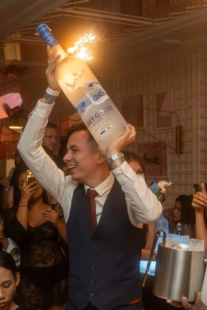 waiter holding a bottle of Grey Goose with sparklers at Mami Rose restaurant in Bangkok