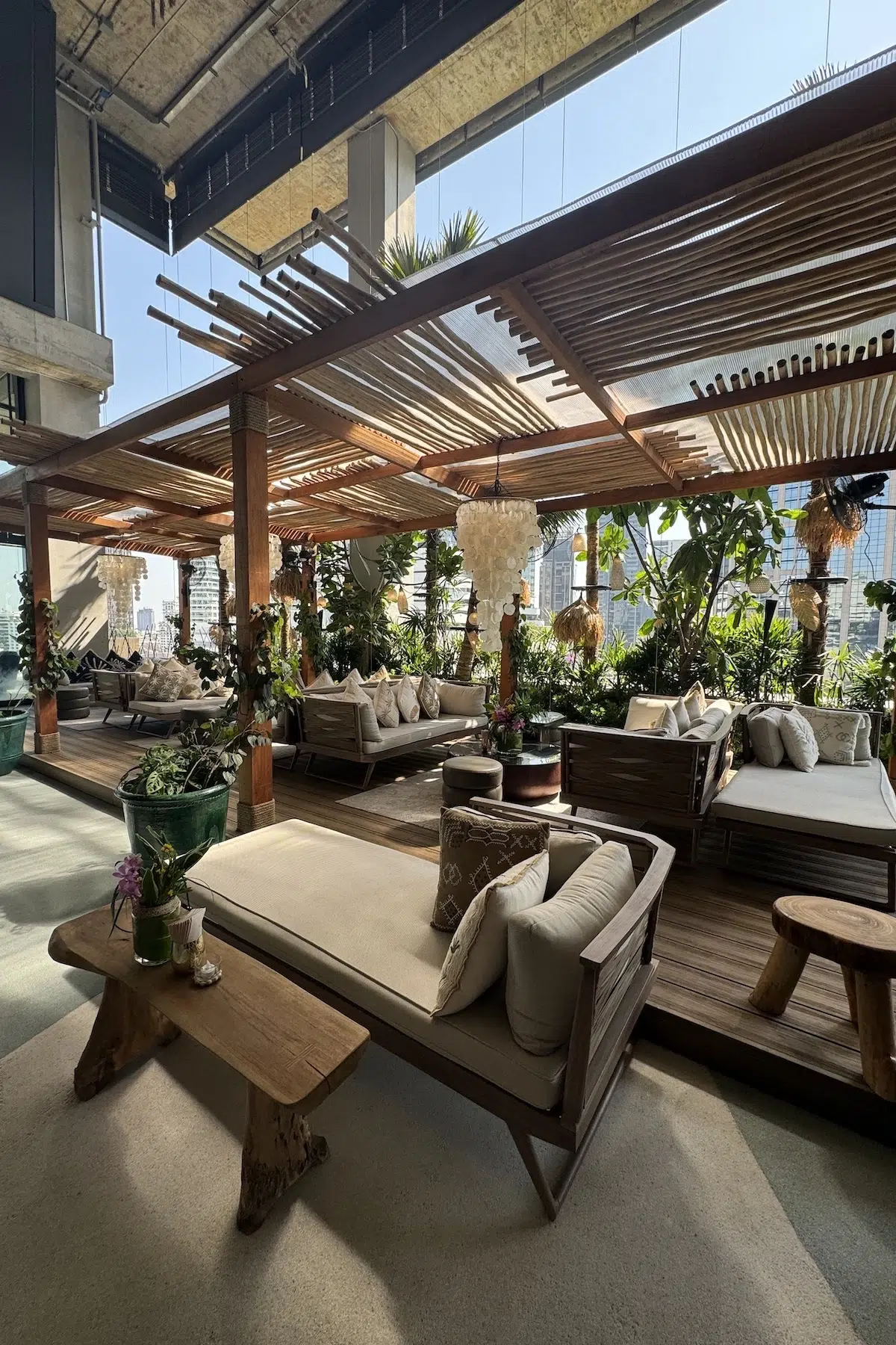 This photo shows the terrace's sofas from Tribe Sky Beach Club located at EmSphere in Bangkok. You can see a mexican-like decor. This place seems to have a cozy vibe atmosphere.